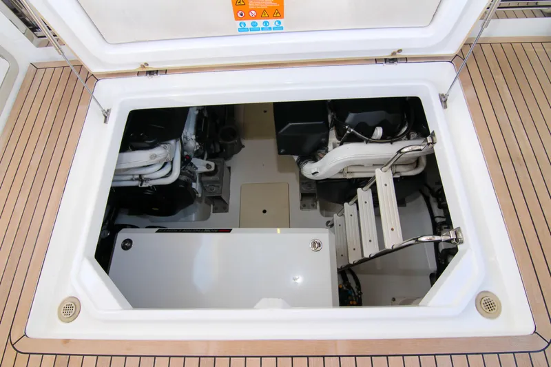 Fortunato Yacht Photos Pics Engine compartment of 2016 Azimut 50 Flybridge yacht, showcasing mechanical components and ladder.
