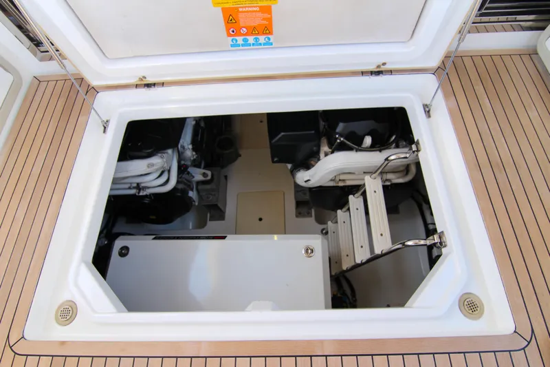 Fortunato Yacht Photos Pics Engine compartment of 2016 Azimut 50 Flybridge yacht, showcasing mechanical components and access ladder.