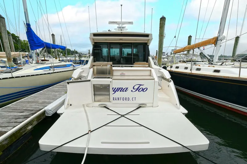  Yacht Photos Pics 2015 Tiara Yachts C44 Coupe docked at marina, rear view.