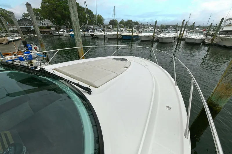  Yacht Photos Pics 2015 Tiara Yachts C44 Coupe docked in a marina, surrounded by other boats.