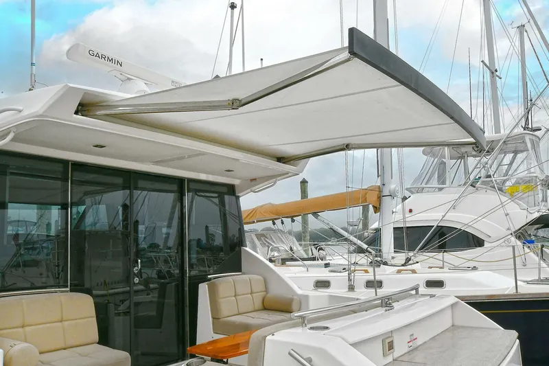  Yacht Photos Pics 2015 Tiara Yachts C44 Coupe with extended awning and seating area in marina.
