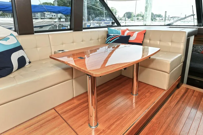 Yacht Photos Pics 2015 Tiara Yachts C44 Coupe interior with elegant seating and polished wood table.