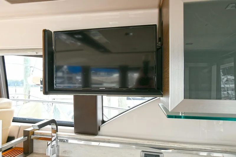  Yacht Photos Pics Flat-screen TV in 2015 Tiara Yachts C44 Coupe interior, near window and cabinetry.