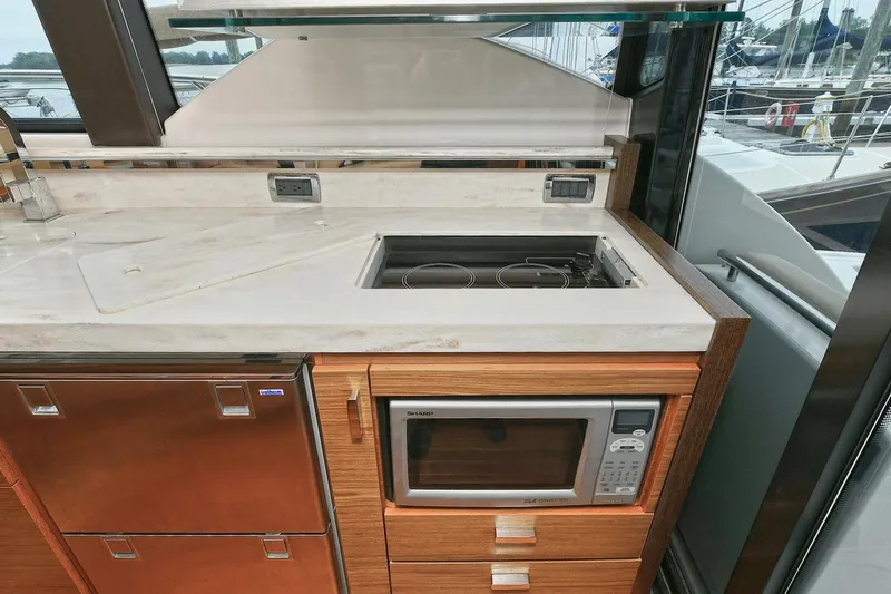  Yacht Photos Pics Modern kitchen area in 2015 Tiara Yachts C44 Coupe with microwave and stovetop.