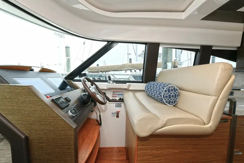  Yacht Photos Pics 2015 Tiara Yachts C44 Coupe helm with leather seating and modern controls.