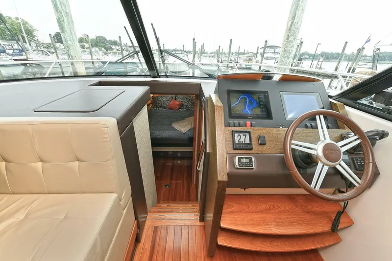  Yacht Photos Pics Interior of 2015 Tiara Yachts C44 Coupe with helm, seating, and navigation display.