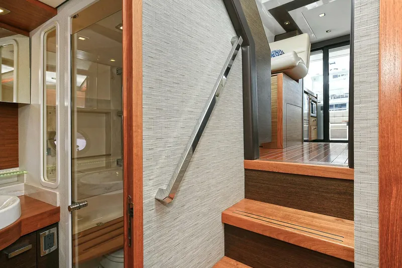  Yacht Photos Pics Interior of 2015 Tiara Yachts C44 Coupe, featuring wooden stairs and modern design elements.