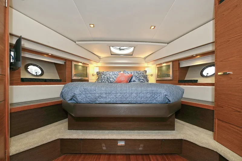  Yacht Photos Pics Luxurious interior of 2015 Tiara Yachts C44 Coupe with elegant bedding and modern design.