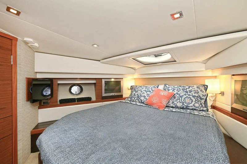  Yacht Photos Pics Luxurious bedroom interior of 2015 Tiara Yachts C44 Coupe with elegant bedding and modern design.