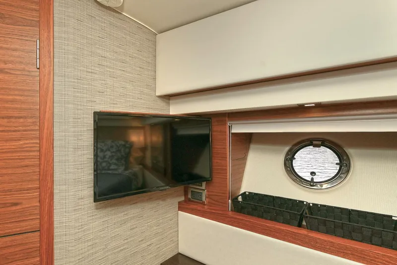  Yacht Photos Pics Interior of 2015 Tiara Yachts C44 Coupe with TV and porthole window.