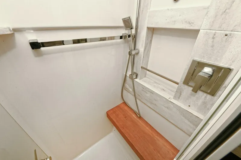  Yacht Photos Pics Shower area in 2015 Tiara Yachts C44 Coupe with wooden bench and modern fixtures.
