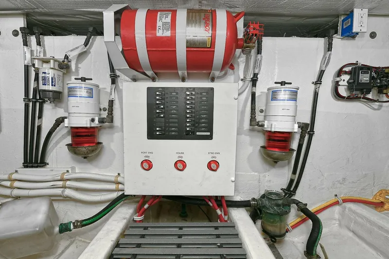  Yacht Photos Pics Engine room of 2015 Tiara Yachts C44 Coupe with fire suppression system and control panel.