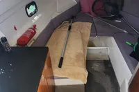Interior of a 2022 Karnic CS 700HT boat with fishing gear and fire extinguisher.