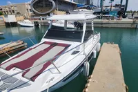 2022 Karnic CS 700HT boat docked in a marina, featuring sleek design and sunbathing area.