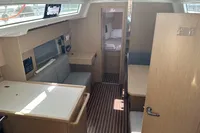 2024 Bavaria C38 yacht interior with modern wood finish and cozy seating area.