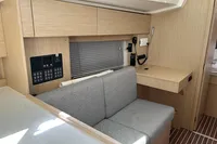 2024 Bavaria C38 yacht interior with modern wood finish and control panel.