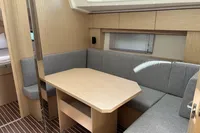 2024 Bavaria C38 yacht interior with modern wood finish and cozy seating area.
