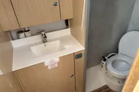 Modern bathroom in 2024 Bavaria C38 yacht with sink and toilet.