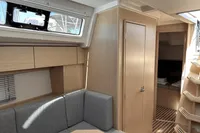 2024 Bavaria C38 yacht interior with modern wood finish and cozy seating area.