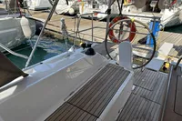 2024 Bavaria C38 yacht docked, showcasing sleek deck design and modern steering wheel.