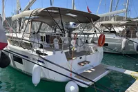 2024 Bavaria C38 yacht docked in marina, featuring modern design and spacious deck.