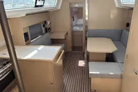 2024 Bavaria C38 yacht interior with modern wood finish and cozy seating area.