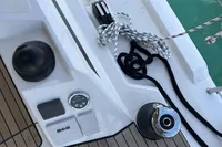 Deck of 2024 Bavaria C38 yacht with ropes and control panel.