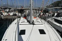 2024 Bavaria C38 yacht docked at marina, surrounded by other sailboats under clear skies.