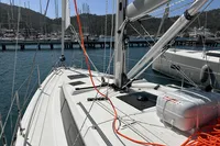 2024 Bavaria C38 sailboat docked at marina, featuring sleek deck and vibrant orange ropes.