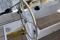 Steering wheel of 2024 Bavaria C38 yacht with teak deck and modern design.