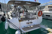 2024 Bavaria C38 yacht docked in marina, featuring spacious deck and modern design.