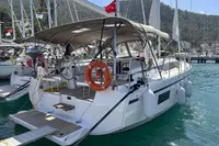 2024 Bavaria C38 yacht docked in marina, featuring modern design and spacious deck.