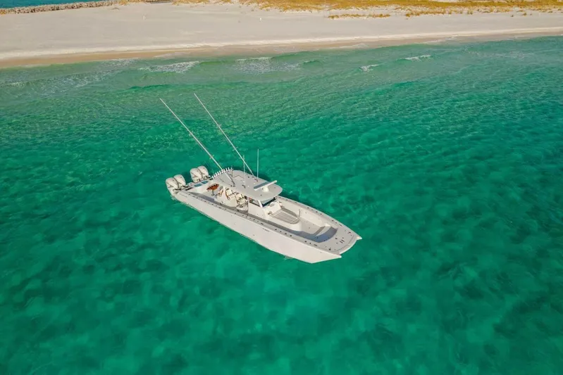 Just Looking Yacht Photos Pics Aerial view of 2024 Freeman 47 boat on clear turquoise water near sandy beach.