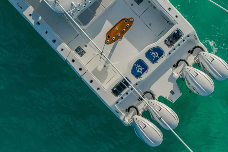 Just Looking Yacht Photos Pics Aerial view of 2024 Freeman 47 boat with four engines on turquoise water.