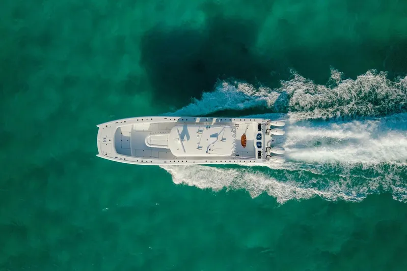 Just Looking Yacht Photos Pics Aerial view of 2024 Freeman 47 boat cruising on turquoise water.