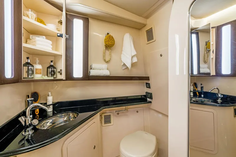  Yacht Photos Pics Manufacturer Provided Image: 2022 Grady-White Canyon 456 boat bathroom with sink, toilet, and storage shelves.