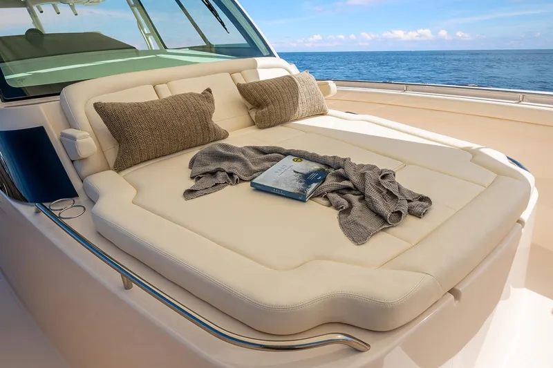  Yacht Photos Pics Manufacturer Provided Image: Luxurious sunbed on 2022 Grady-White Canyon 456 boat with pillows and blanket.
