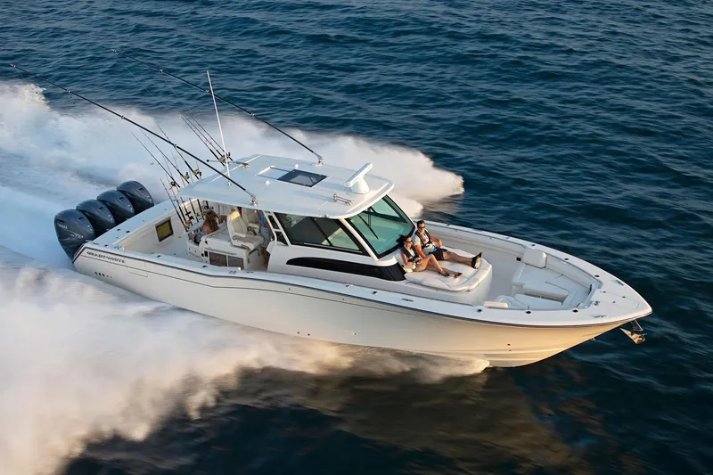  Yacht Photos Pics Manufacturer Provided Image: 2022 Grady-White Canyon 456 boat speeding on the water with fishing rods.