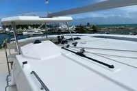 2020 Leopard 45 catamaran docked at marina under blue sky.