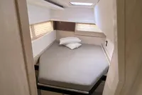 Cozy bedroom in 2020 Leopard 45 yacht with modern design and natural light.