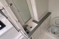 Modern bathroom in 2020 Leopard 45 yacht with shower, sink, and toilet.