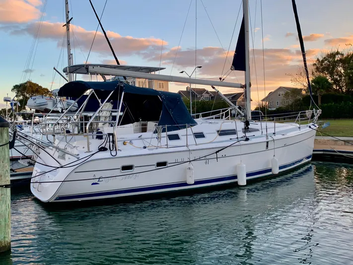 Light Seeker Yacht Photos Pics 2005 Hunter 41 AC sailboat docked at marina during sunset.