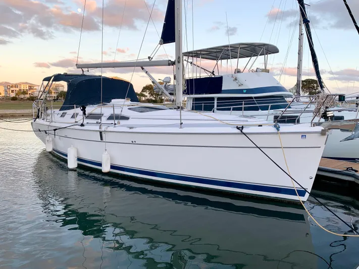 Light Seeker Yacht Photos Pics 2005 Hunter 41 AC sailboat docked at marina during sunset.