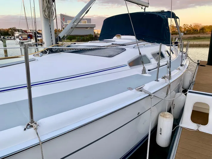 Light Seeker Yacht Photos Pics Sailboat docked at marina, 2005 Hunter 41 AC model, with blue canopy and white hull.