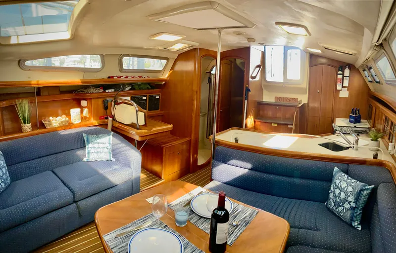 Light Seeker Yacht Photos Pics Interior of 2005 Hunter 41 AC yacht with cozy seating and dining area.