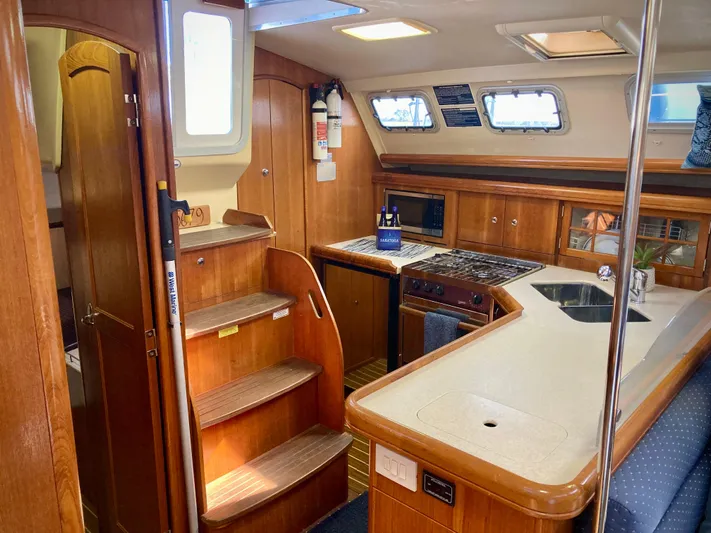 Light Seeker Yacht Photos Pics Interior of 2005 Hunter 41 AC sailboat with wooden cabinetry and modern kitchen amenities.