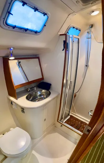 Light Seeker Yacht Photos Pics Compact bathroom in 2005 Hunter 41 AC yacht with shower, sink, and toilet.