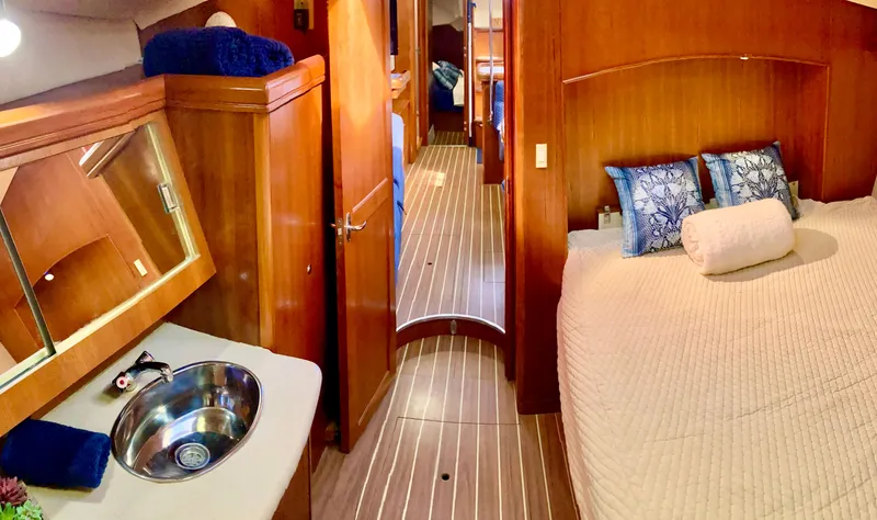 Light Seeker Yacht Photos Pics Luxurious interior of 2005 Hunter 41 AC yacht with cozy bedroom and elegant wood finish.