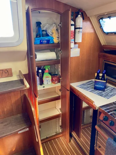 Light Seeker Yacht Photos Pics Interior of 2005 Hunter 41 AC sailboat with open cabinet and kitchen essentials.