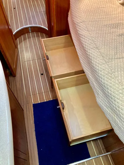 Light Seeker Yacht Photos Pics Wooden drawers under bed in 2005 Hunter 41 AC yacht interior.